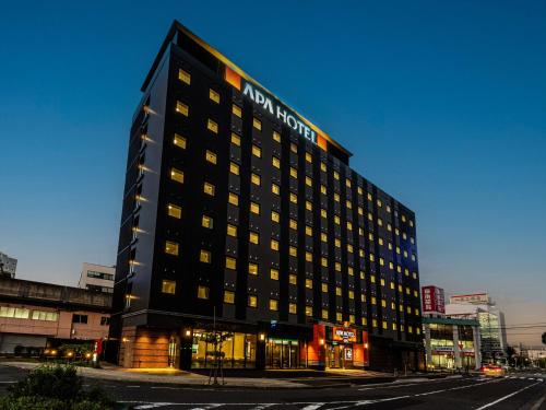 a hotel building with a sign on the side of it at APA Hotel Tottori Ekimae in Tottori