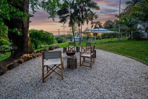 a group of chairs and a fire pit in a park at Hinterland Retreat l Fire Pit Scenic Views l Nova Escapes in Goonengerry