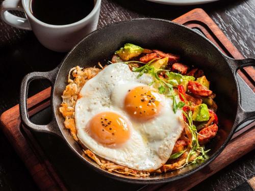 a pan with two fried eggs on top of food at Fairmont Chicago Millennium Park in Chicago