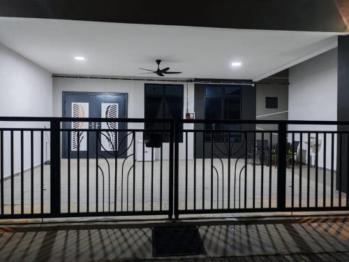 a balcony with a black fence and a door at Homestay Q Haven in Kuantan
