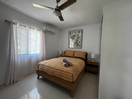 a bedroom with a bed and a ceiling fan at Rest & Relax at The Secret Garden Getaway in Harrisons Pocket