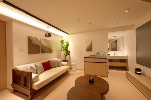a living room with a couch and a table at Qinghai Xisu in Dalian