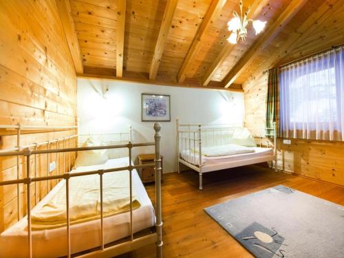 a bedroom with two bunk beds in a wooden cabin at Holiday Village Wildschönau Family Chalet in Niederau