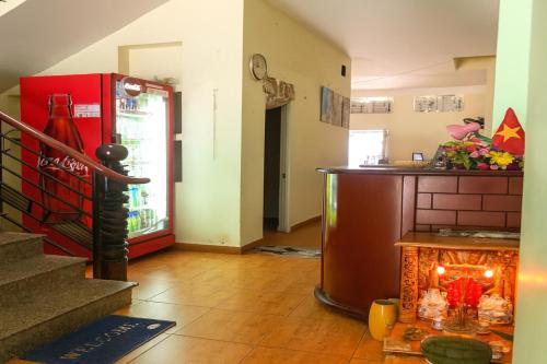 a living room with a counter and a refrigerator at Thanh Tùng Hotel HCM in Ho Chi Minh City