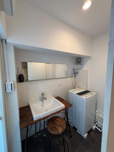 a bathroom with a sink and a washing machine at Kamakura S house in Yokohama