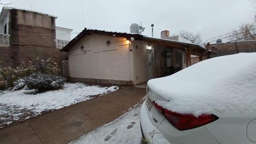 a snow covered car parked in front of a house at Artin House Mendoza in Ciudad Lujan de Cuyo