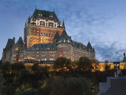 a large building with a tower on top of it at Fairmont Le Chateau Frontenac in Quebec City