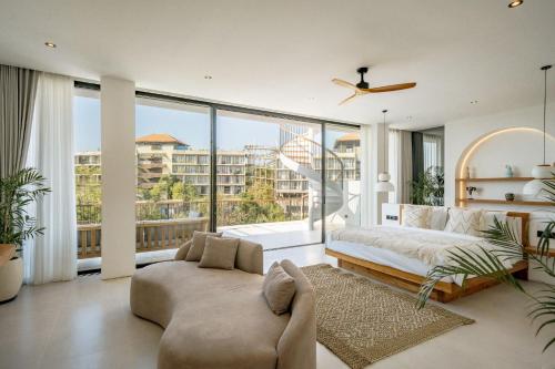 a bedroom with a bed and a large window at Elements B3 Villa Bingin in Bingin Beach