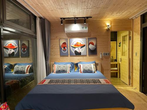 a bedroom with a large bed in a room at Son Bá Mười Ecolodge 