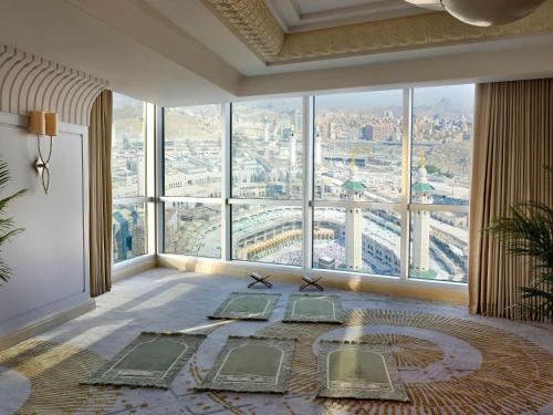 a room with a large window with a view of a city at Raffles Makkah Palace in Makkah