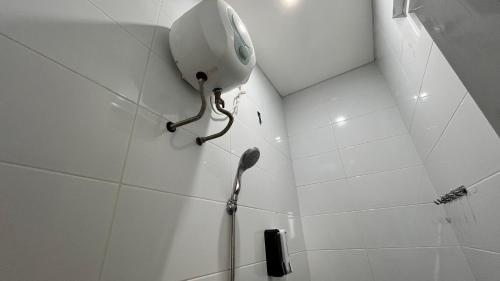 a shower with a shower head in a bathroom at Hause of Bejo Yogyakarta in Demangan