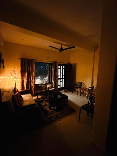 a living room with a couch and a table at The Hp 39 House in Dharmsala