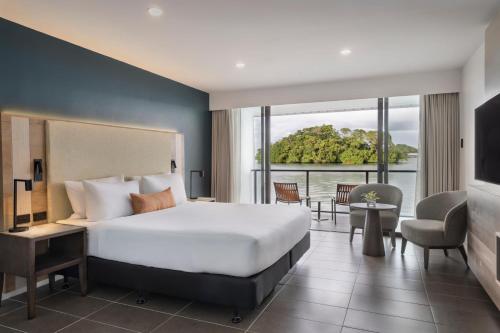 a hotel room with a bed and a large window at Novotel Suva Lami Bay in Suva