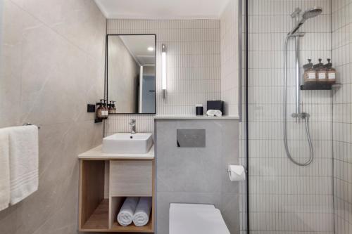 a bathroom with a sink and a shower at Novotel Suva Lami Bay in Suva