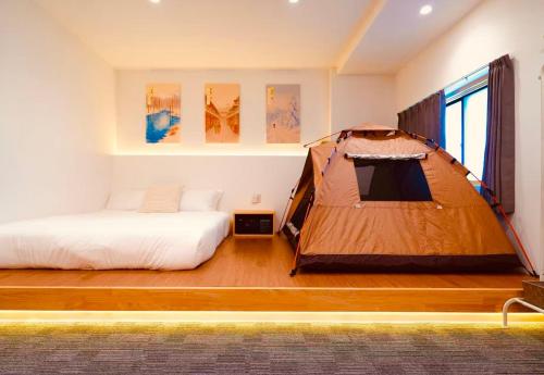 a bedroom with a tent and a bed at YUKI YAMA Hotel in Osaka