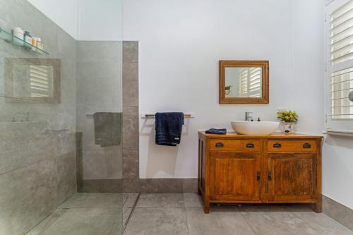 a bathroom with a sink and a shower at Hazeldene, charm & vines in Heathcote