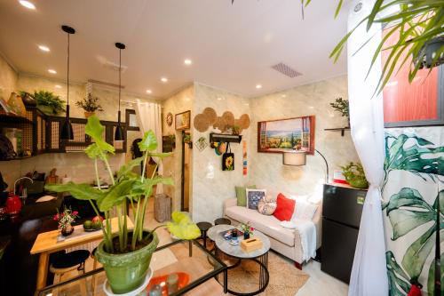 a living room with a couch and a table at Mía&Nho Stay - Ground Floor, Old Quarter Hai Phong in Hai Phong