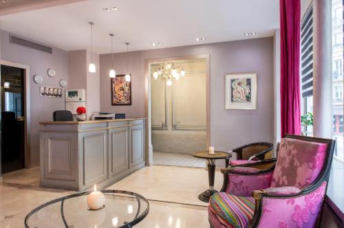 a living room with two chairs and a table at Hotel Corona -Rodier- in Paris