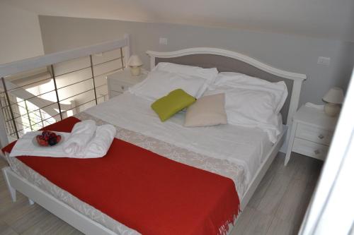 a white bed with towels and pillows on it at Al Centro Suites in Sorrento