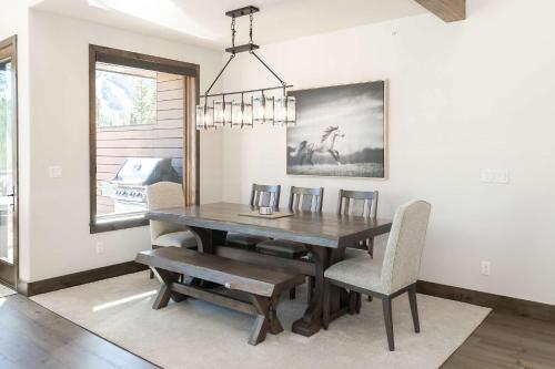 a dining room with a wooden table and chairs at Evergreen Reserve in Winter Park
