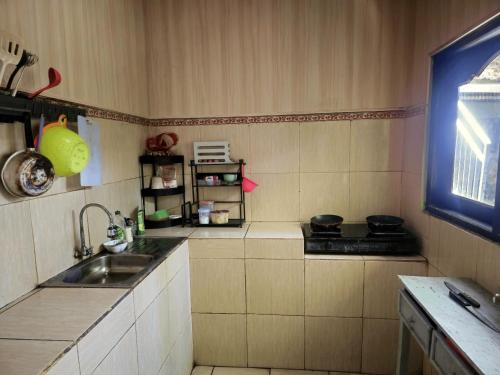 a kitchen with a sink and a stove at green view downtown in Ubud