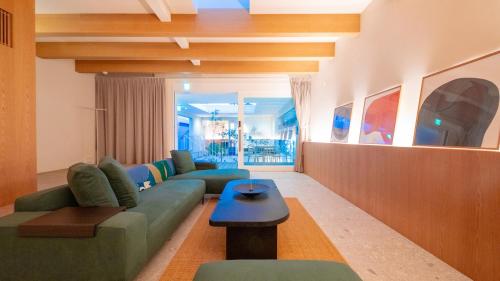 a living room with a couch and a table at Hotel 二灯 in Beppu