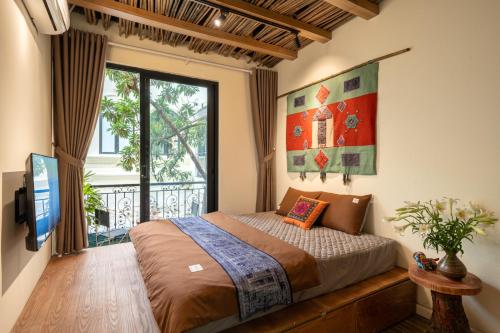 a bedroom with a bed and a large window at La Belle Sol Villa in Heart of City Center-Free Laundry in Hanoi