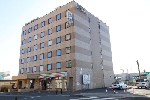 a building with a car parked in a parking lot at Hotel Migrant - Vacation STAY 81204v in Tateyama