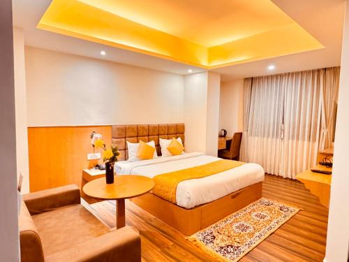 a hotel room with a bed and a couch at Staynest Continetal With parking Near Mg Marg in Gangtok