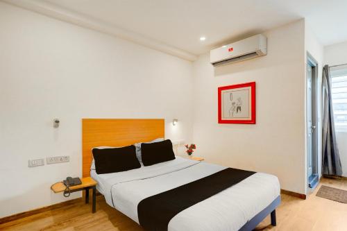 a bedroom with a large bed in a room at Townhouse Sarjapur Road Formerly Hotel Ace in Bengaluru