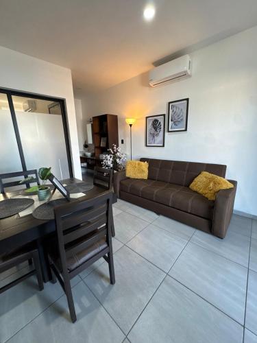 a living room with a couch and a table at Loft, Departamento cerca del Malecon, MAZATLAN in Mazatlán
