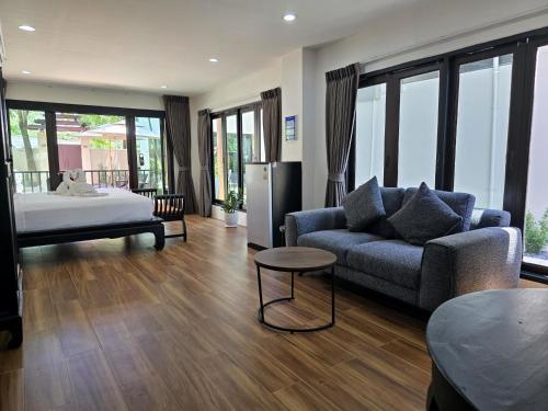 a living room with a couch and a bed at Blue Palm Residence Kata in Kata Beach