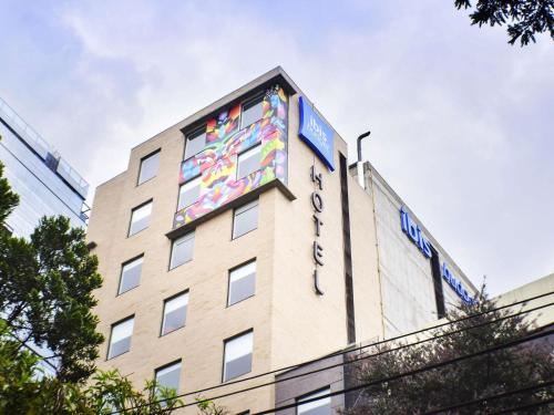 a building with a mural on the side of it at ibis budget Bogota Marly in Bogotá
