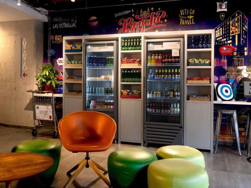 a bar with a refrigerator with drinks in it at ibis budget Bogota Marly in Bogotá