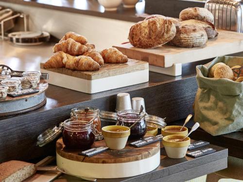 a bakery with various types of bread and croissants at 25hours Hotel Florence Piazza San Paolino in Florence