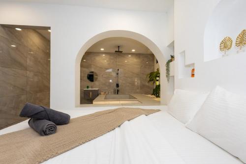 a bedroom with a bed and a bath tub at The Oasiis Private Pool Retreat in Johor Bahru
