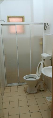 a bathroom with a toilet and a sink at Numero X homestay in Kajang