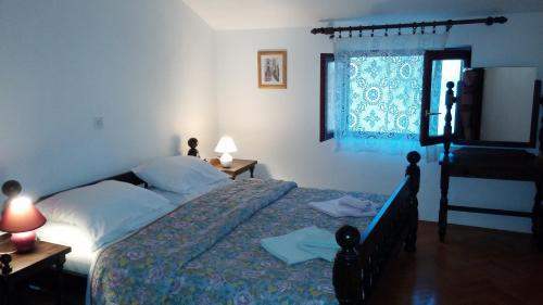 a bedroom with a bed and a television and a window at Holiday Home Arina in Medulin