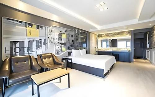 a hotel room with a bed and a couch at Pohang Hotel View in Pohang