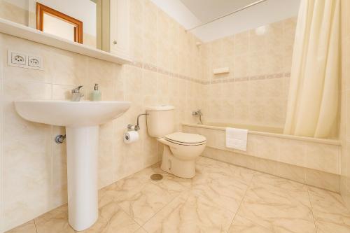 a bathroom with a toilet and a sink at Be five Playa La Arena in Puerto de Santiago