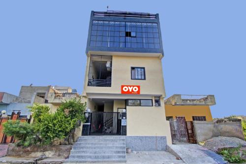 a building with a sign that reads oxy at Hotel O Green Apple in Jaipur