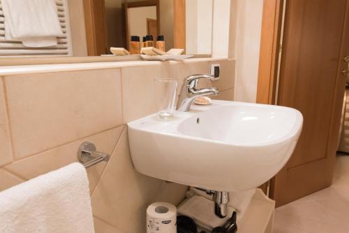 a bathroom with a white sink and a mirror at Residenza Marchesi Pontenani in Florence