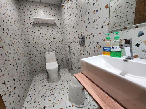 a bathroom with a sink and a toilet at HOTEL SUN town in Ahmedabad