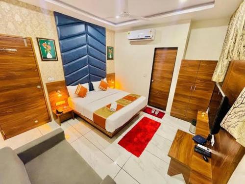 a large bedroom with a bed and a room with at HOTEL SUN town in Ahmedabad