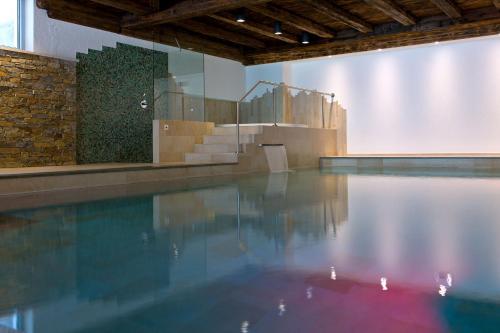 a swimming pool in a building with a staircase at Hotel Waldruhe in Gsies