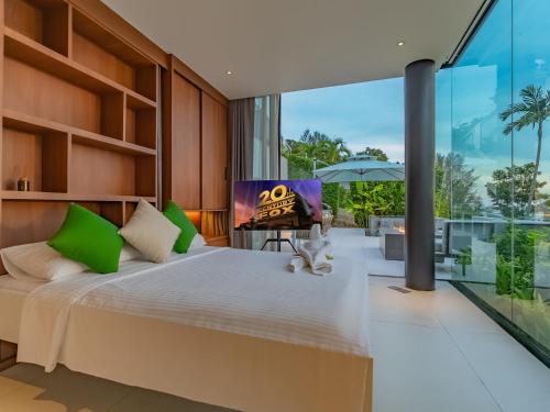 a bedroom with a large bed with green pillows at NEW Luxury 4BR Villa in Layan - Villa Zuma in Layan Beach