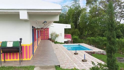a house with a swimming pool in the yard at Finca El Turpial in Alcalá