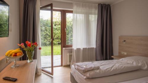a bedroom with a bed and a table with fruit on it at Ahorn Hotel in Munich