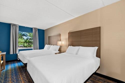 a hotel room with two beds and a window at Quality Inn Shepherdstown in Shepherdstown