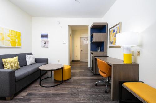a living room with a couch and a table at Comfort Suites Oil Center in Lafayette